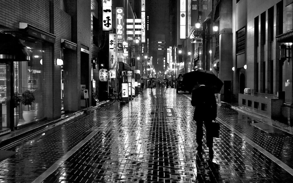 Moody Black and White Wallpaper: Rainy City Street with Neon Lights