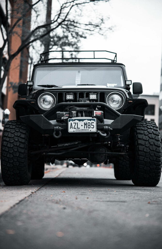 Urban Wallpaper: Rugged Black Jeep Wrangler with Off-Road Tires