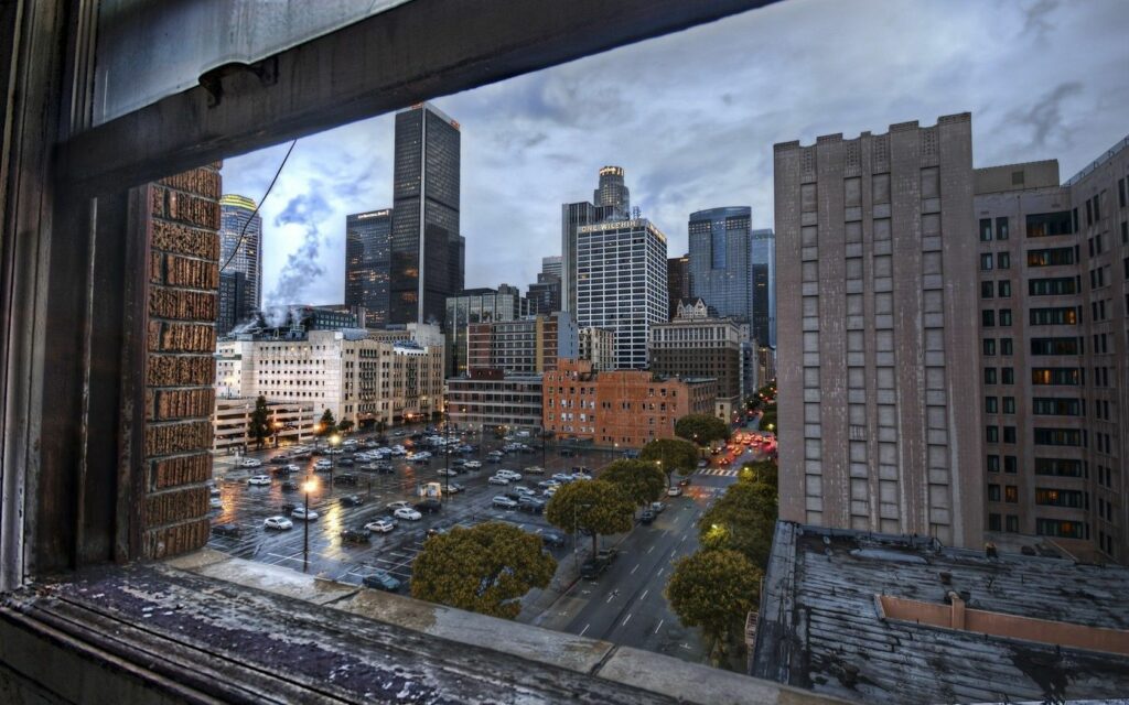 Vibrant Cityscape Wallpaper: Rustic Window Frame Urban View