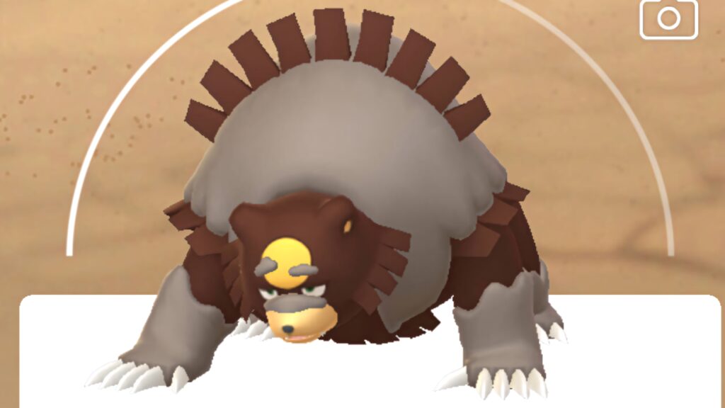 Ursaluna Pokémon fierce battle stance on sandy background wallpaper showcasing power