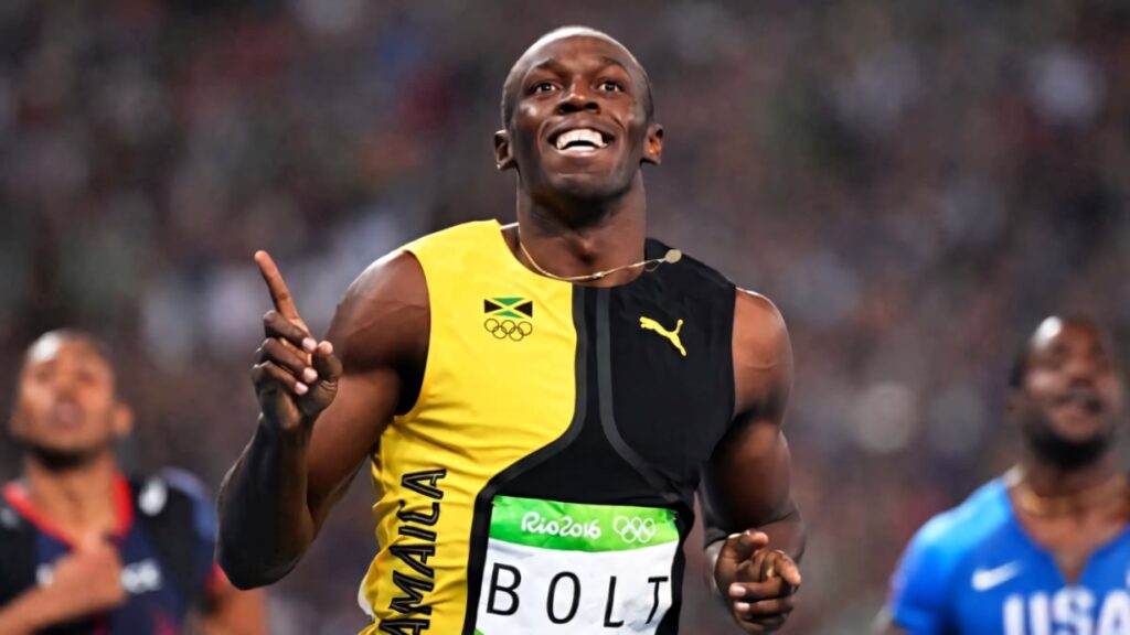 Usain Bolt smiling and pointing up in Jamaica uniform celebrating Rio 2016 Olympics victory wallpaper