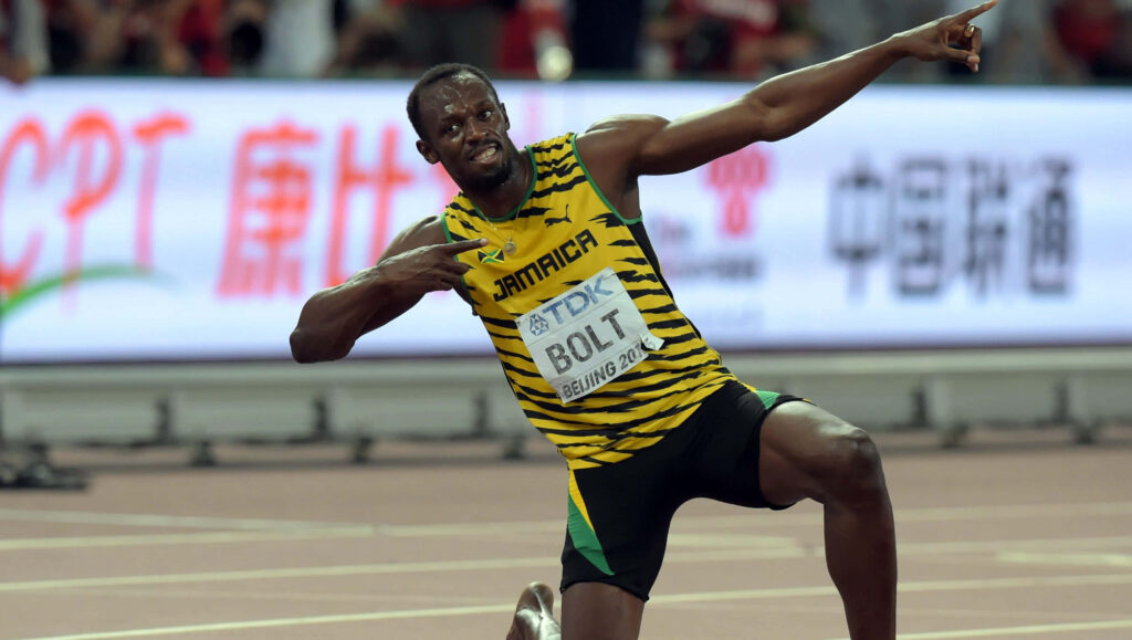 Usain Bolt lightning bolt pose celebrating victory on track dynamic sports wallpaper background