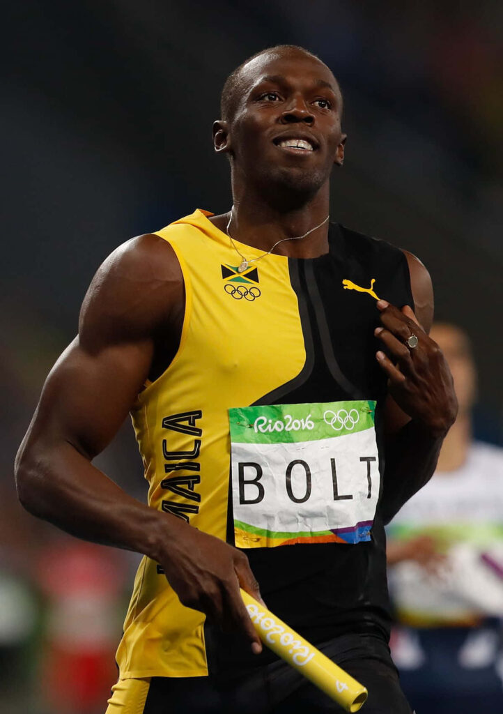 Usain Bolt in black and yellow shirt poised to race at Rio 2016 Olympics track wallpaper