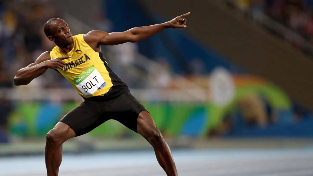 Usain Bolt celebrating victory with iconic pose on track vibrant dynamic sports wallpaper background