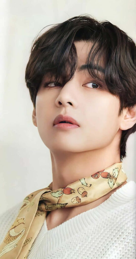 V from BTS with stylish bangs soft gaze and chic fashion phone wallpaper background