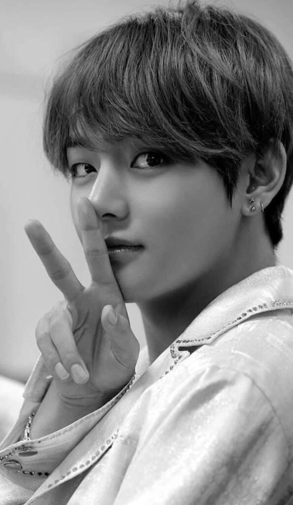 Grayscale BTS V wallpaper showing V making a peace sign stylish phone background for fans
