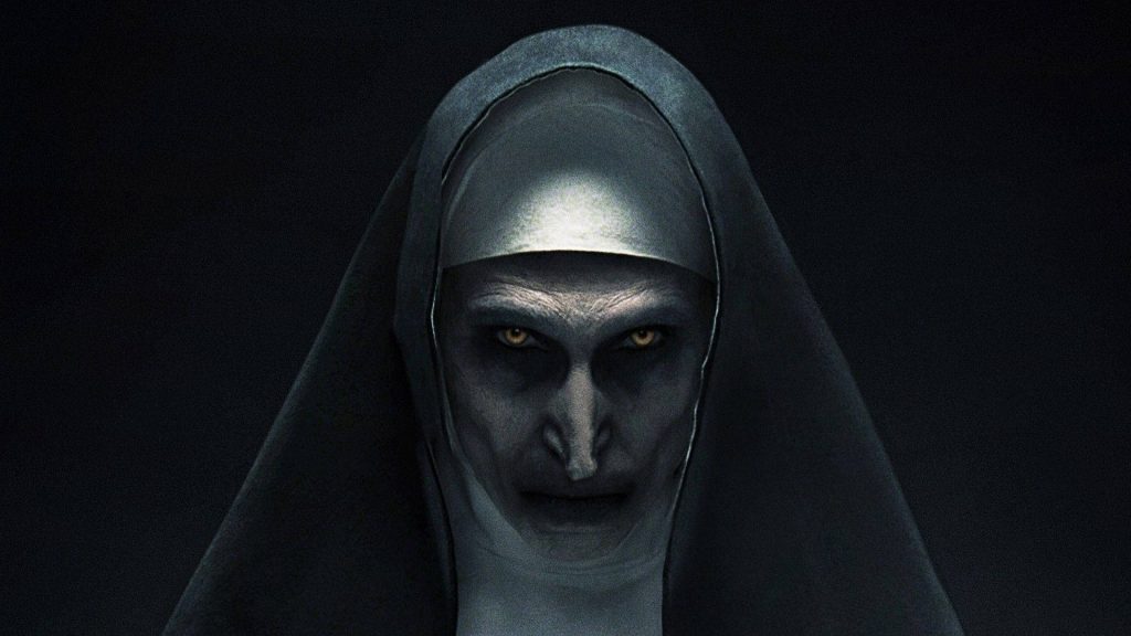 Valak demon nun close-up horror wallpaper with piercing eyes dark habit Conjuring background
