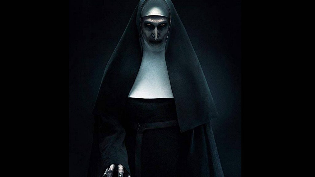 Valak demon nun from The Conjuring dark horror wallpaper with yellow eyes and cracked pale face