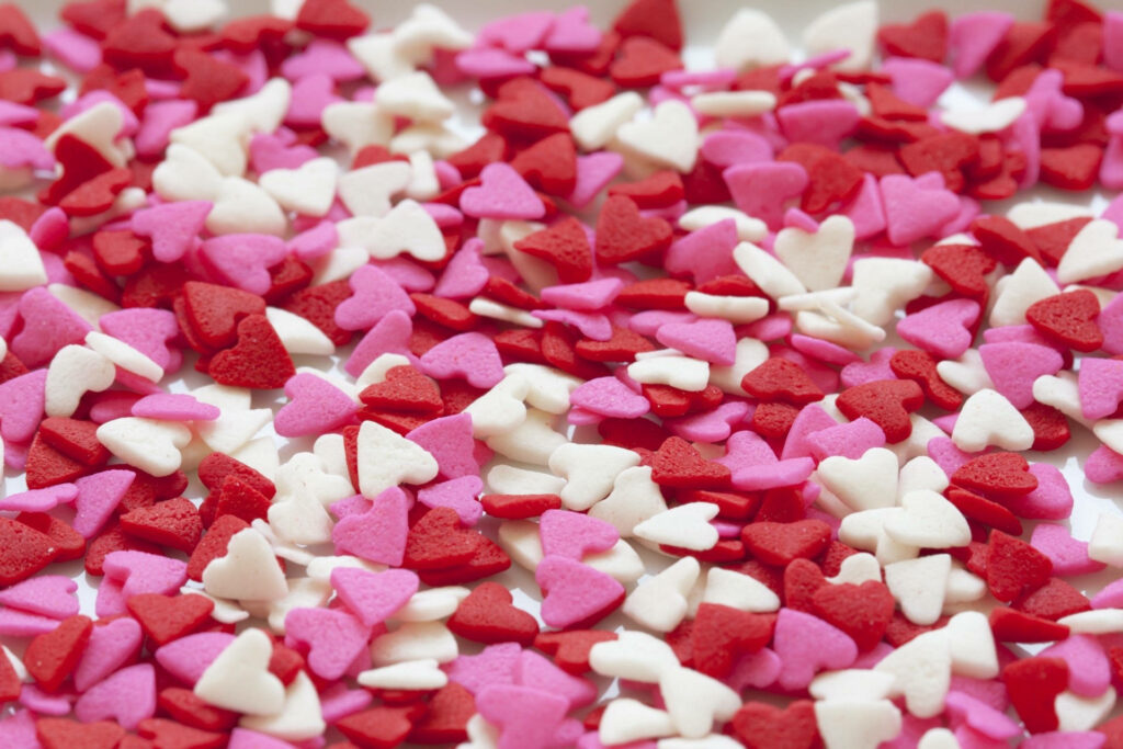 Valentine’s Day heart candy wallpaper with pink red and white sweet festive background texture