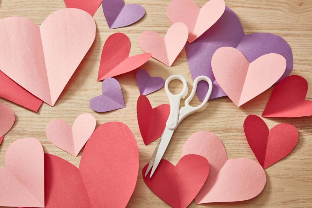 Charming Valentine's Day Wallpaper: Artful Paper Hearts on Wood