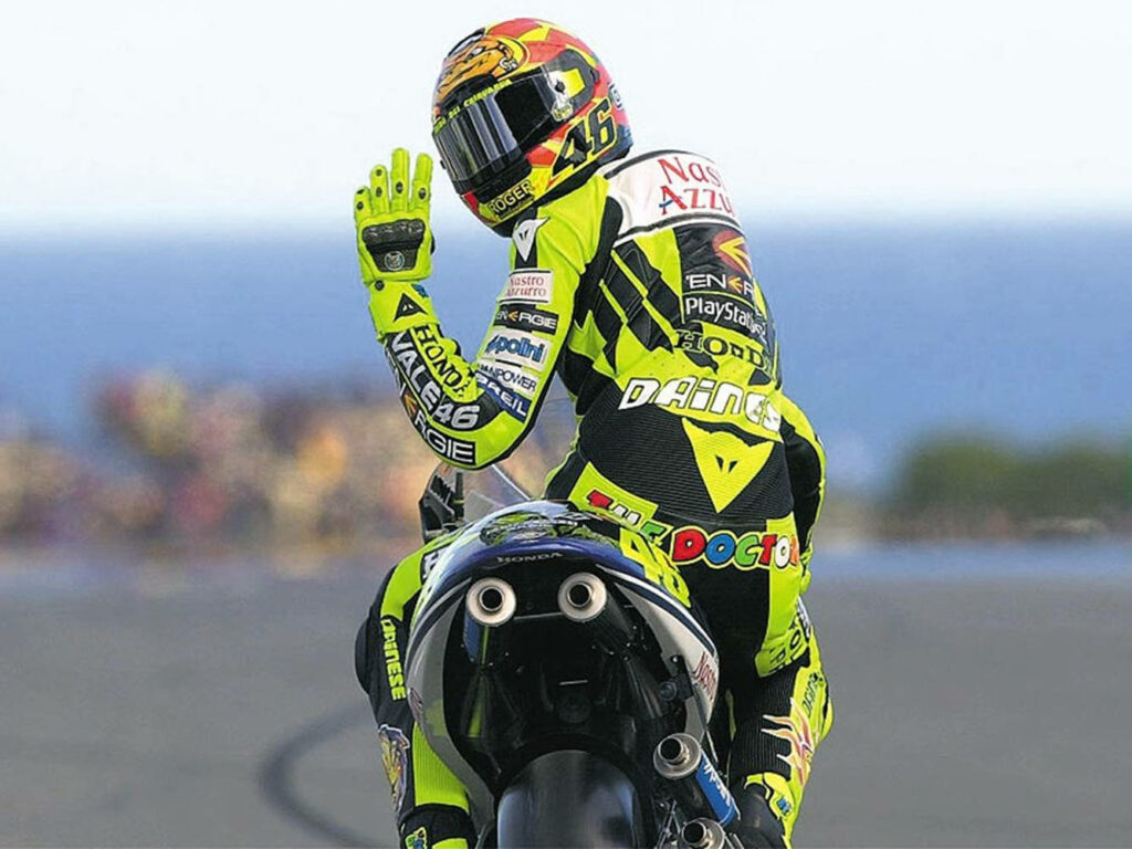 Valentino Rossi on Honda RC211V: Neon Racing Wallpaper Background