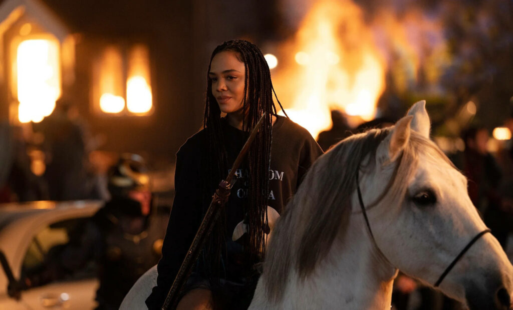 Valkyrie on white horse rides through fiery flames Thor Love and Thunder dramatic wallpaper background