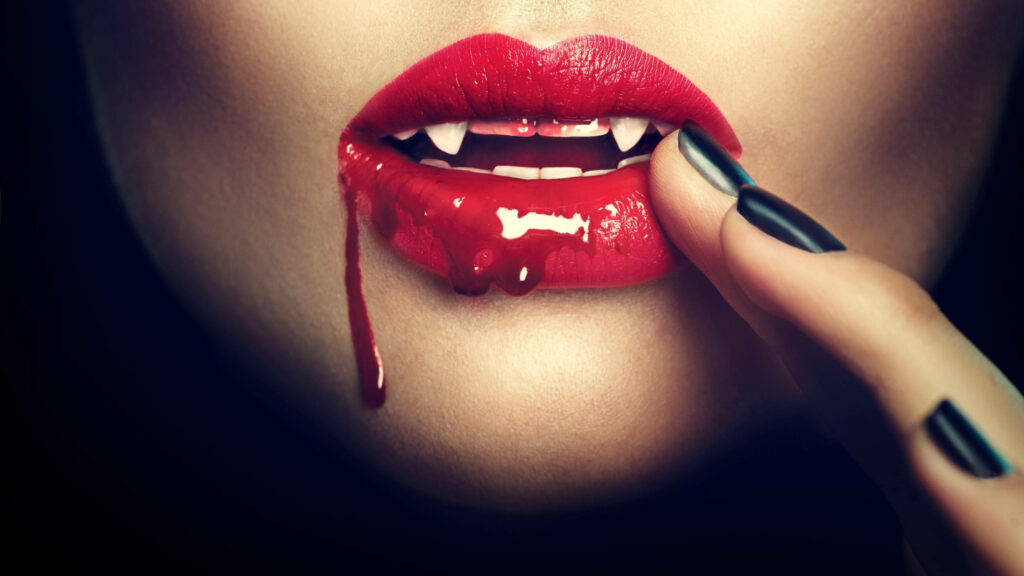 Vampire wallpaper with blood red lips sharp fangs and blood capturing vampire thirst and allure