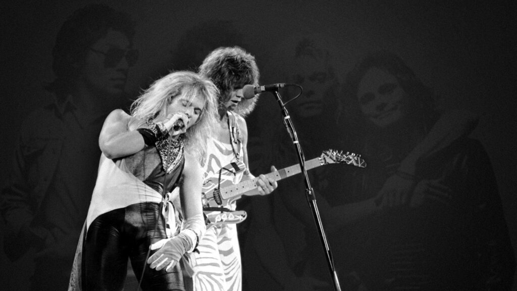 Black and white image of Eddie Van Halen playing striped guitar with David Lee Roth singing live stage Wallpaper