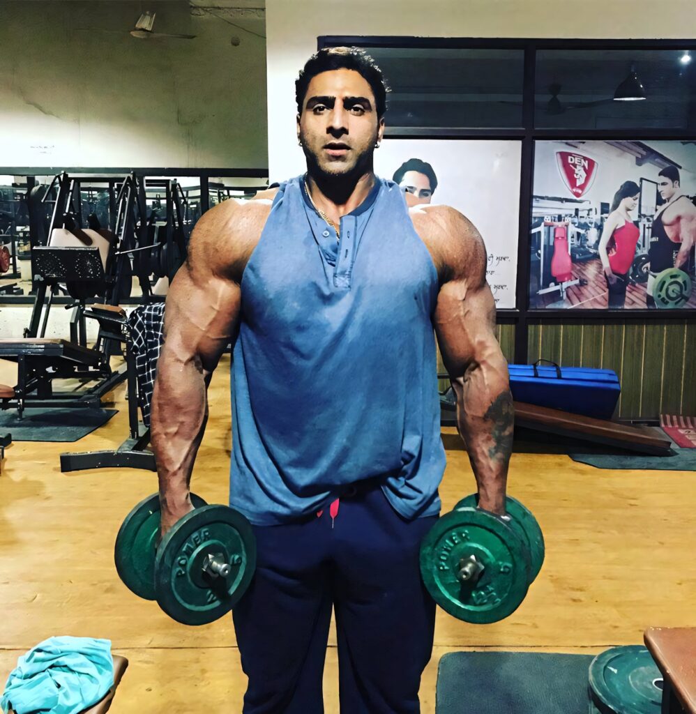 Varinder muscular bodybuilder lifting heavy dumbbells in gym powerful fitness motivation wallpaper