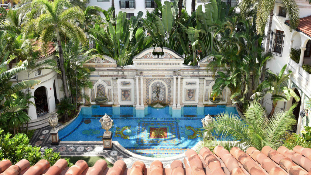 Versace Mansion Florida pool courtyard with Mediterranean architecture and lush tropical palms wallpaper