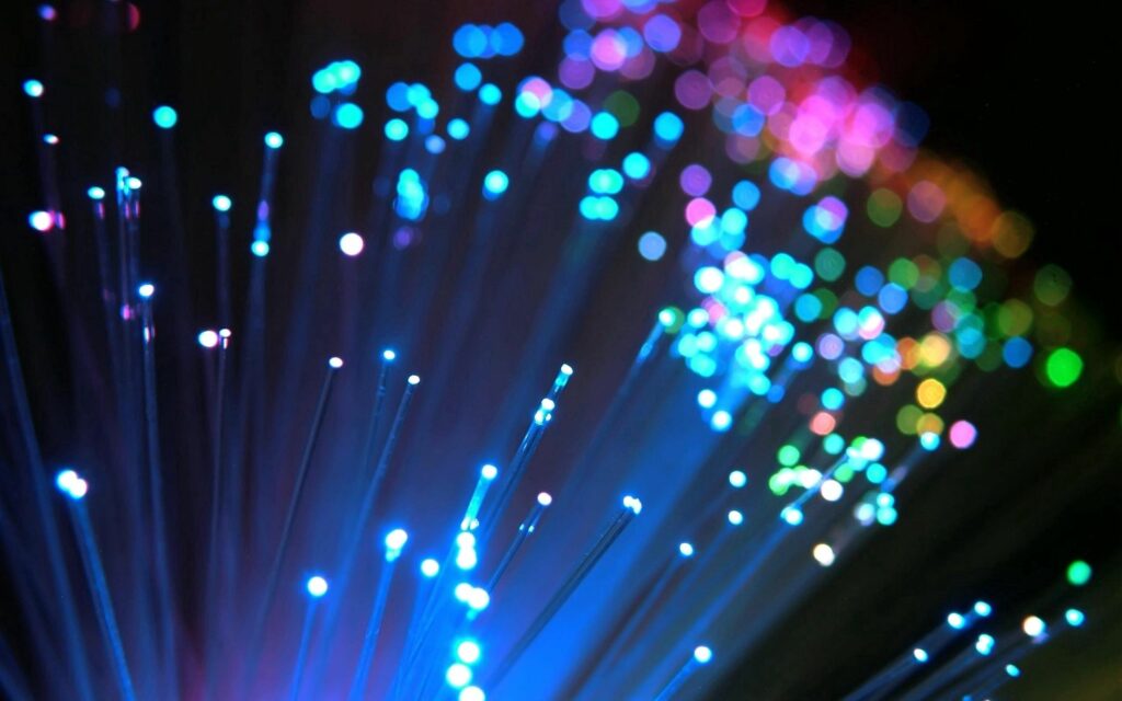 Vibrant 2560x1600 Wallpaper: Colorful Light Particles on Dark Background
