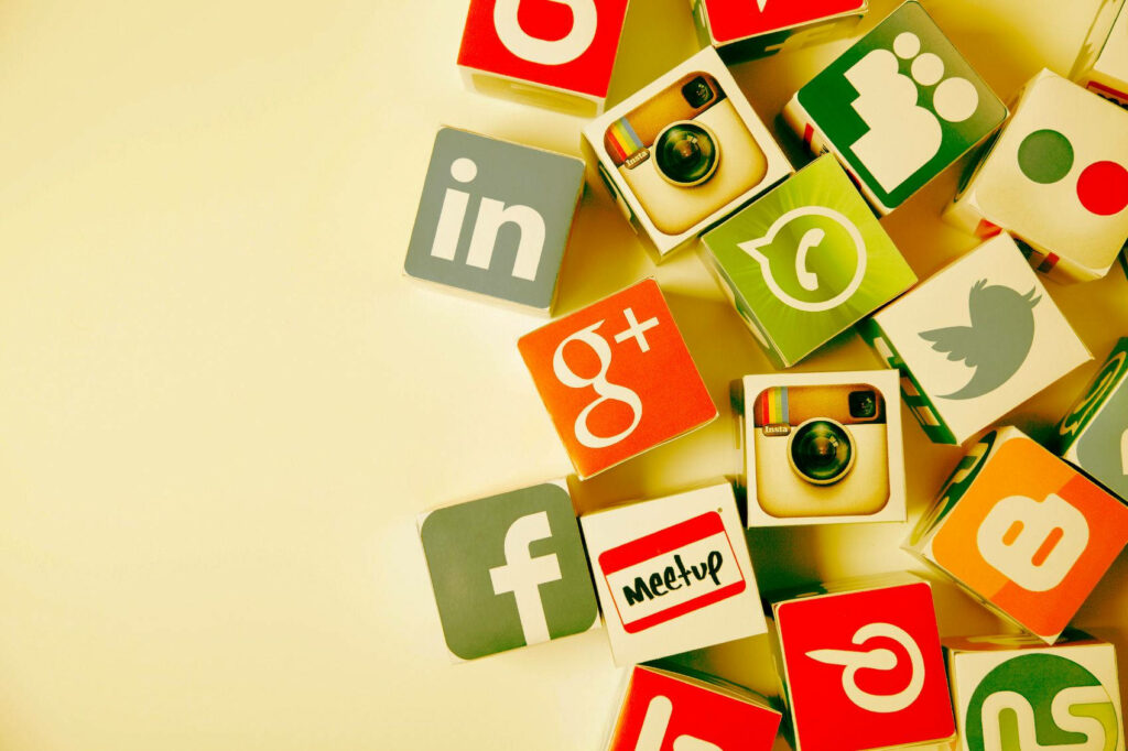 Vibrant 3D Cube Wallpaper of Social Media Logos on Soft Yellow Background
