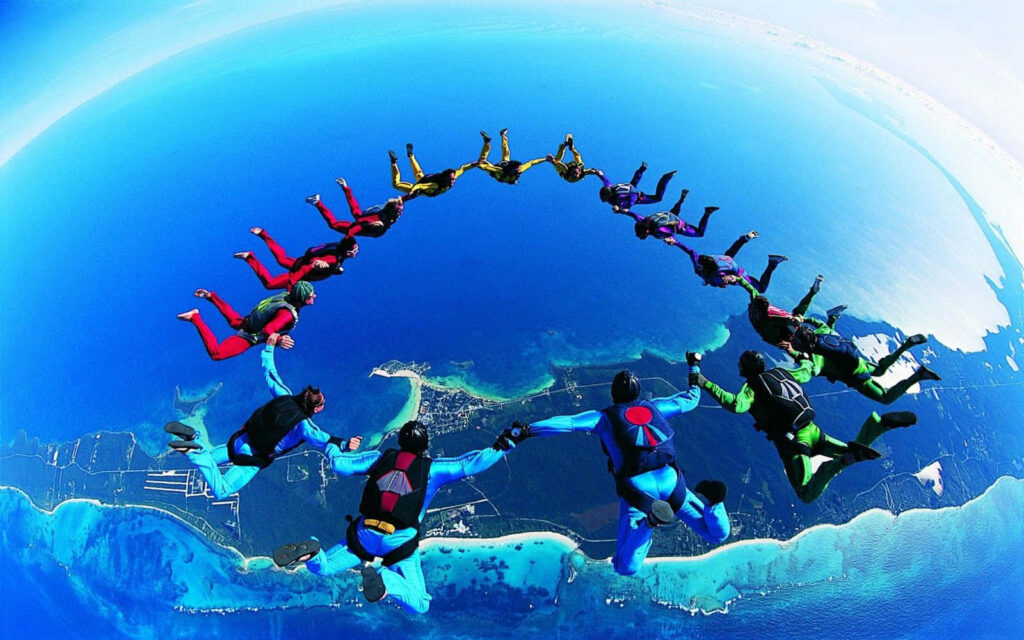 Vibrant 3D Skydivers in Action - Thrilling Coastal Wallpaper