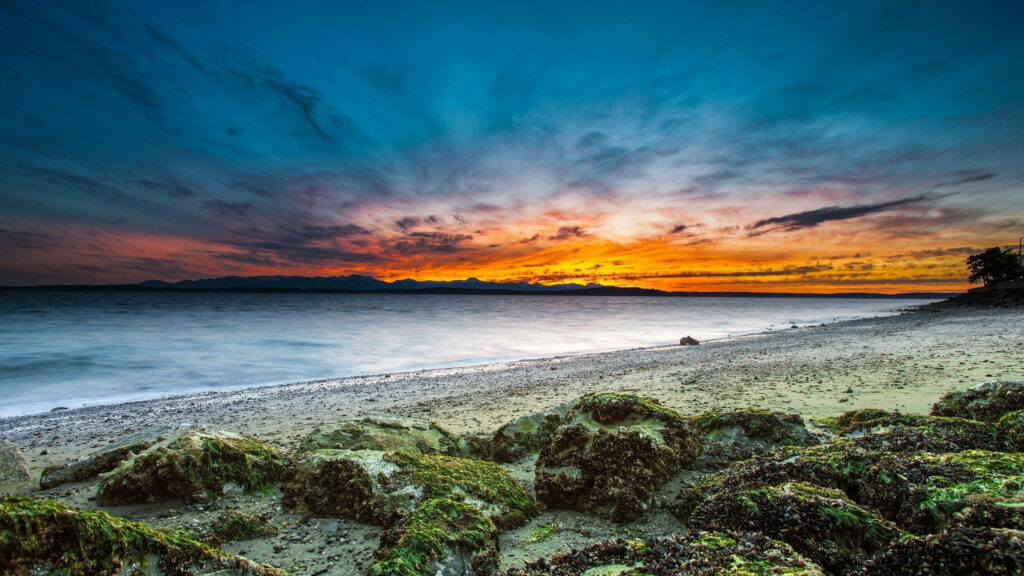 Vibrant 4K Sunset Wallpaper Over Alkai Beach with Rocky Foreground