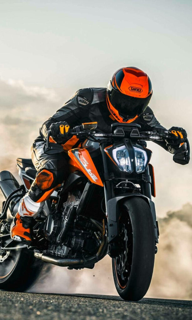Electrifying 4K Wallpaper: Daring Rider on Orange Sports Bike