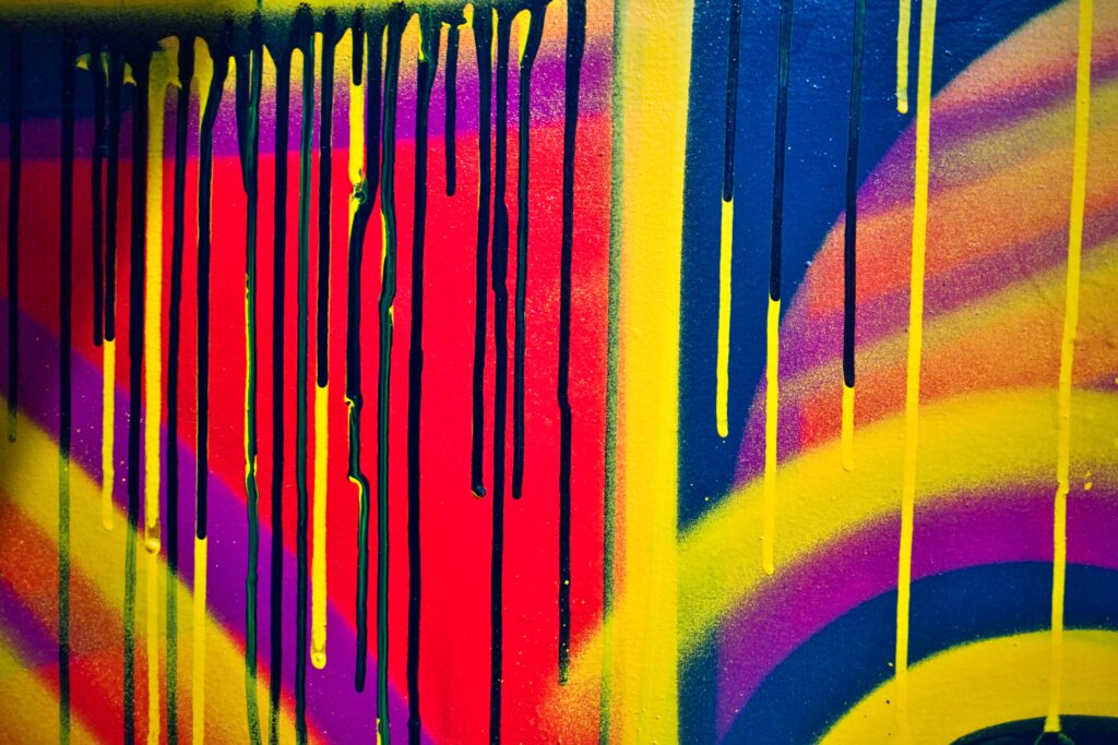 Vibrant Graffiti Art Wallpaper: Neon Yellow Drips on Abstract Background