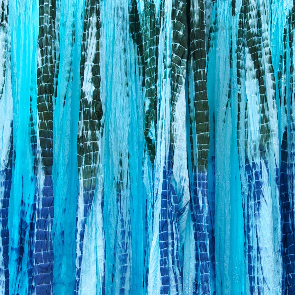 Vibrant abstract wallpaper with cascading turquoise aqua and deep blue streaks and fluid texture