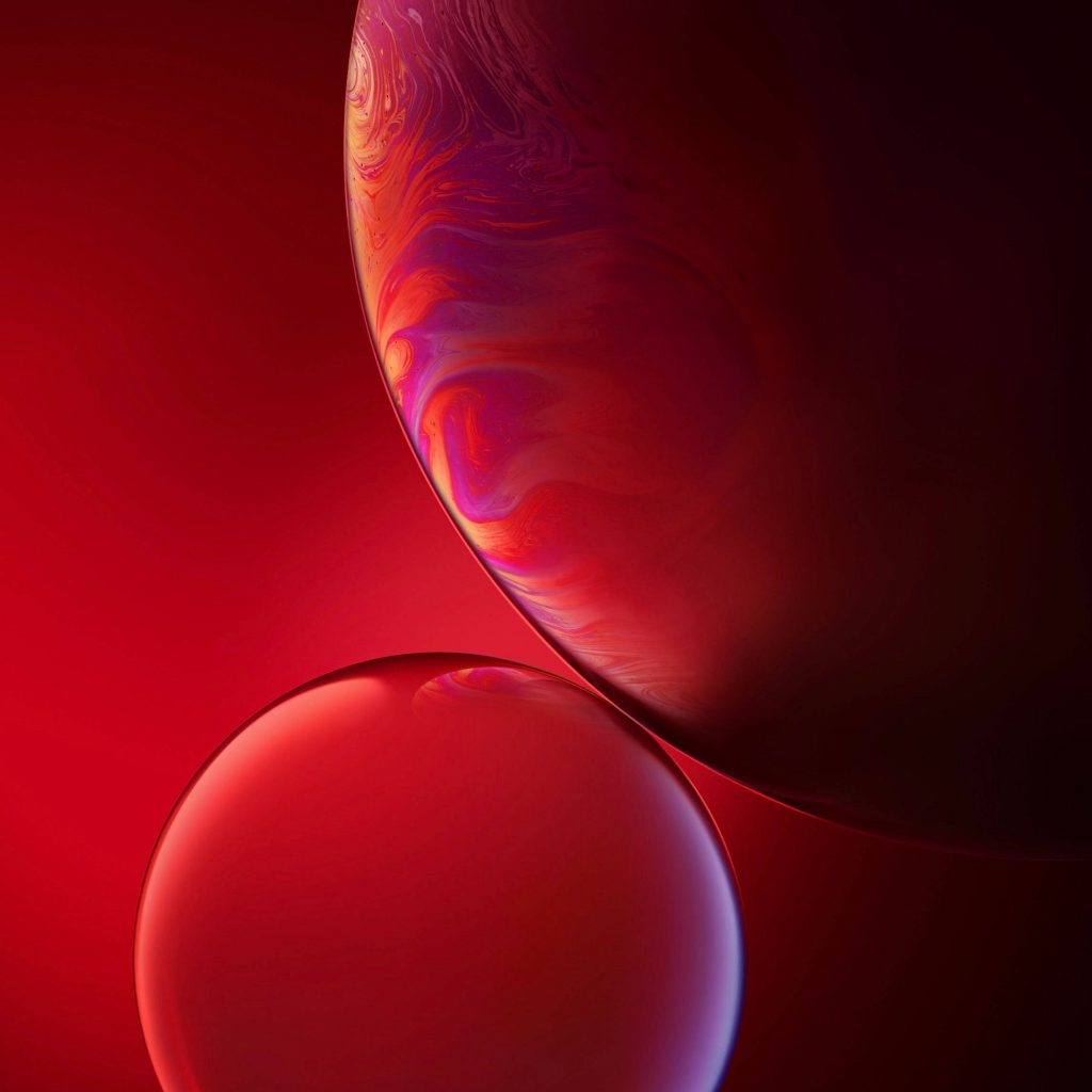 Vibrant iPhone XR wallpaper with swirling red orb and glossy glass bubble on deep crimson background