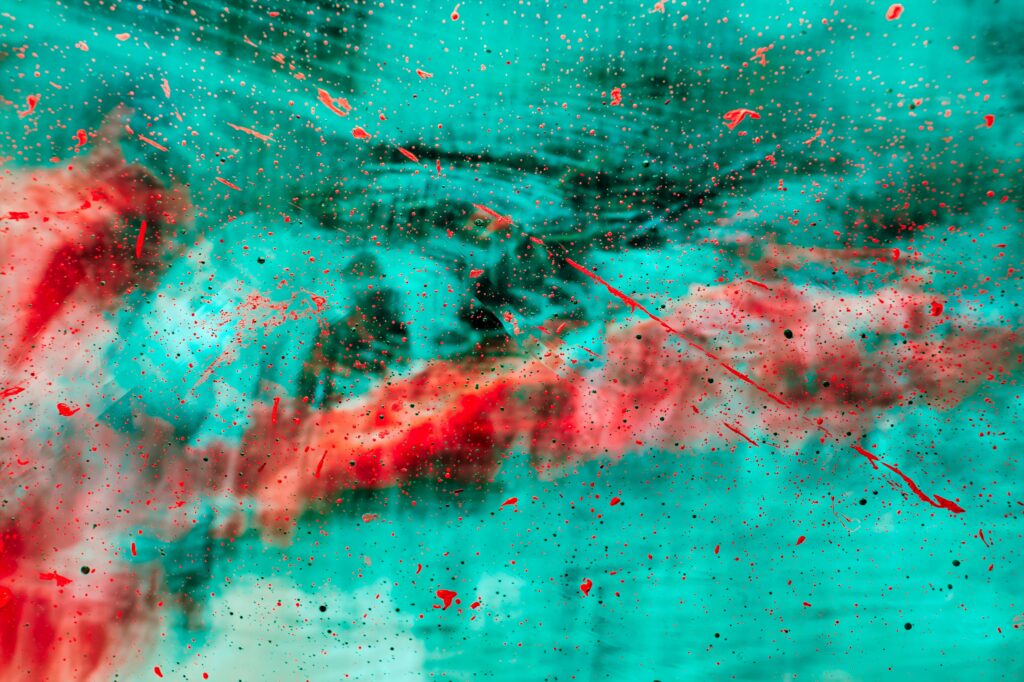 Vibrant Abstract Red Paint Splash Wallpaper on Turquoise Background