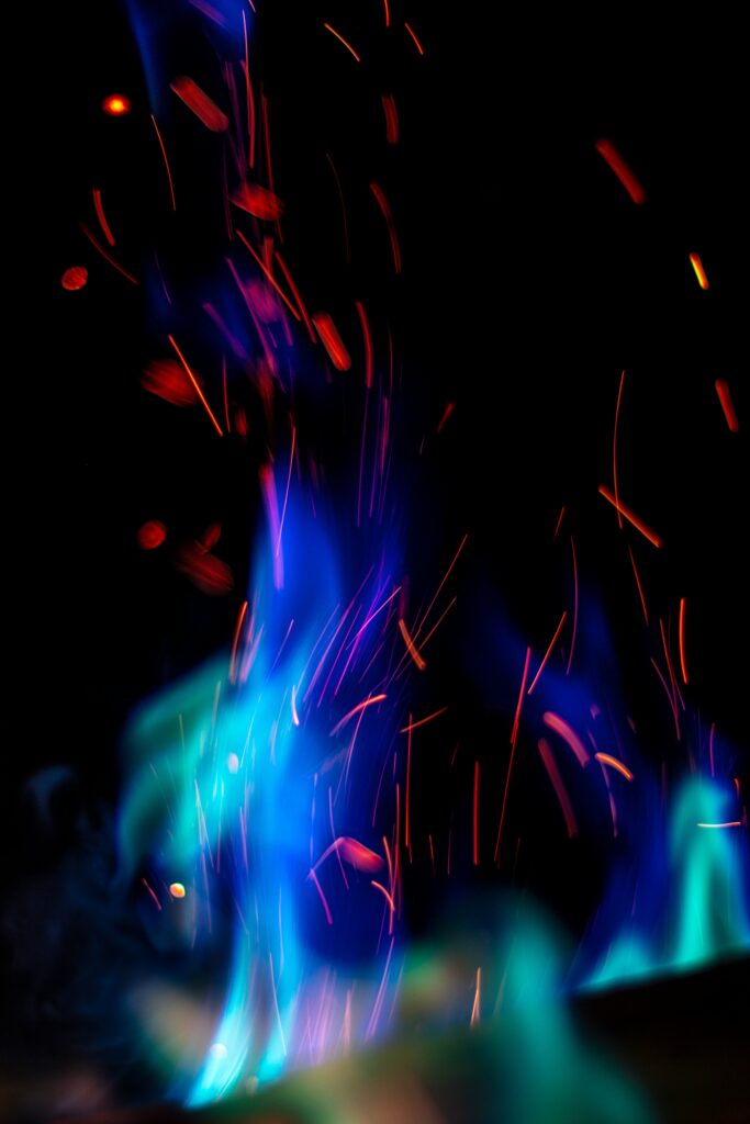 Vibrant Abstract Wallpaper: Blue Flames & Red Sparks on Dark Background