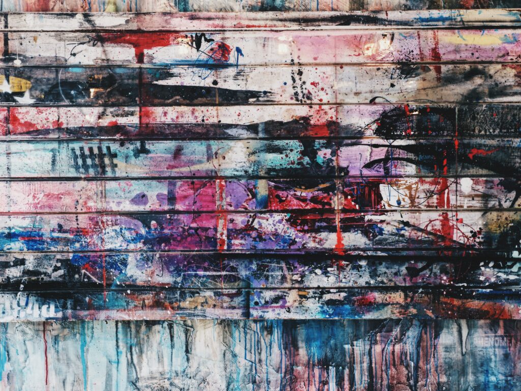Vibrant Abstract Wallpaper: Colorful Paint Splash on Wooden Wall