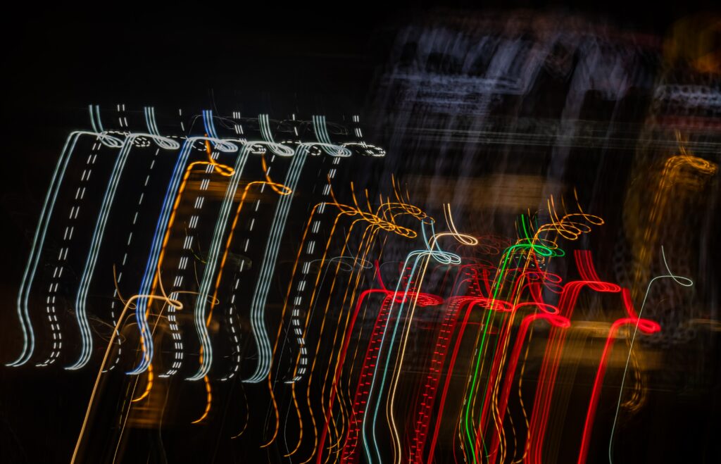 Dynamic Abstract Wallpaper: Colorful Sinuous Lines on Dark Background