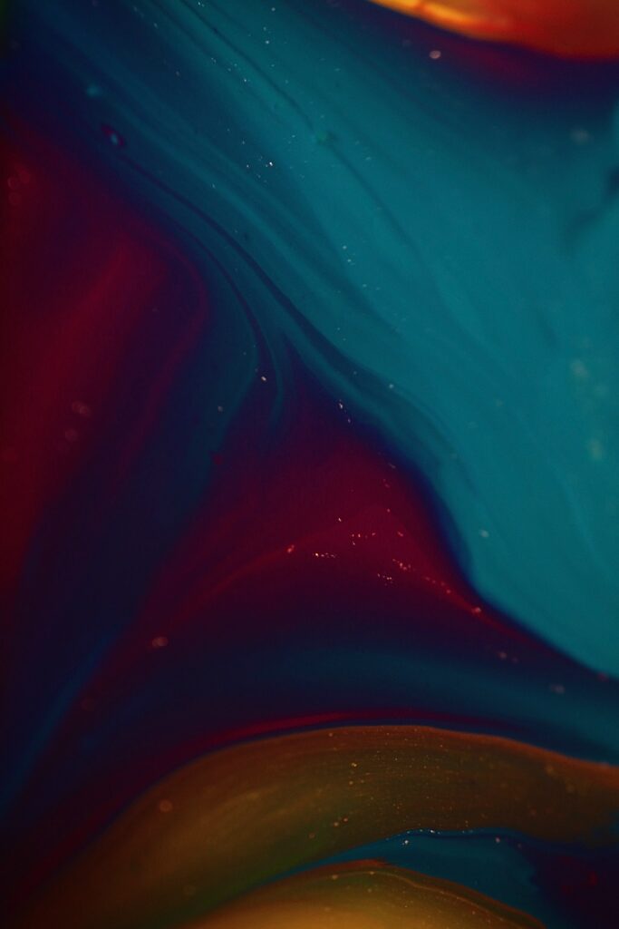 Vibrant Abstract Wallpaper: Fluid Red, Teal & Yellow Design