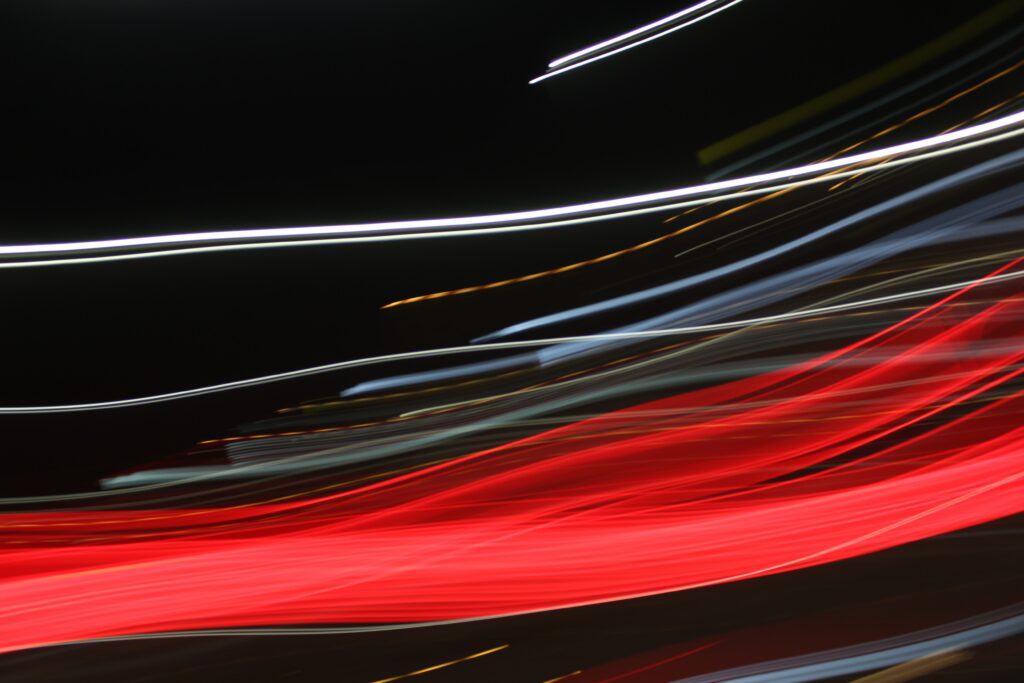 Vibrant Abstract Wallpaper: Dynamic Lines & Light Streaks on Dark Background