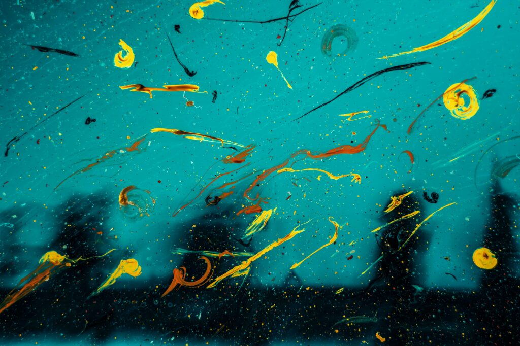 Vibrant Abstract Wallpaper: Paint Splashes on Teal Background