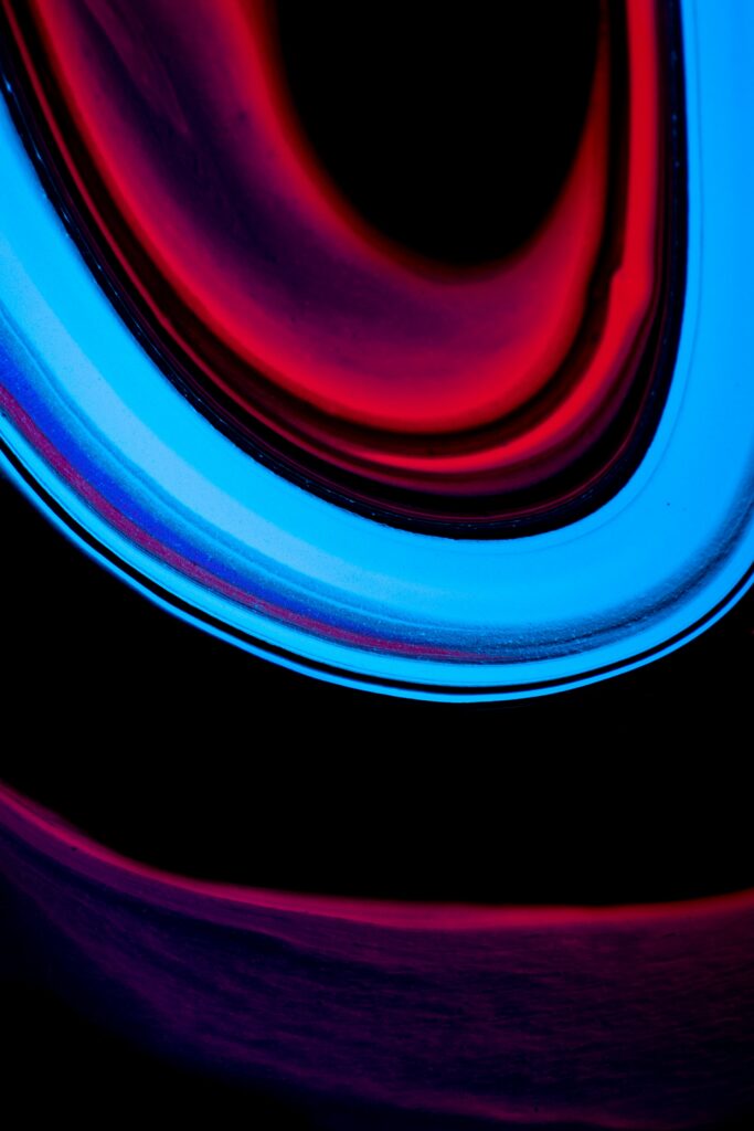 Vibrant Abstract Wallpaper: Red, Blue & Purple Streaks on Dark Background