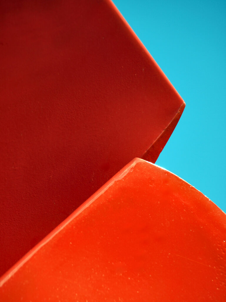Vibrant Abstract Wallpaper: Red Facets on Bright Blue Background