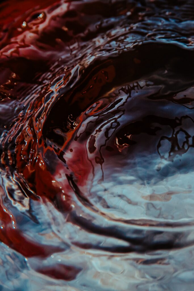 Vibrant Abstract Wallpaper: Swirling Water Patterns in Red & Blue