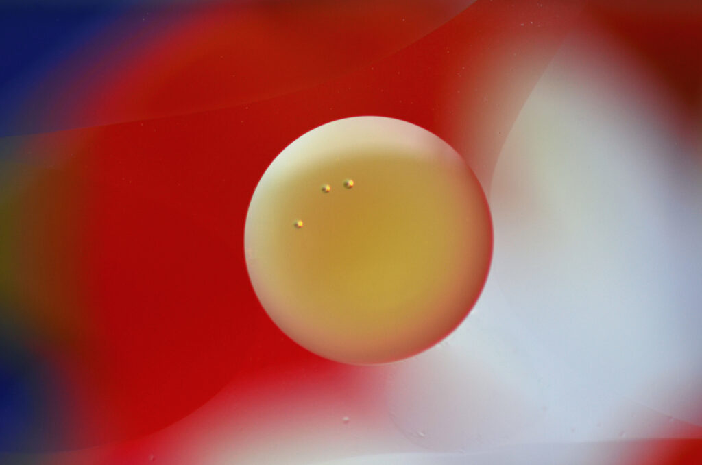 Vibrant Abstract Wallpaper: Translucent Bubble on Dynamic Red Background