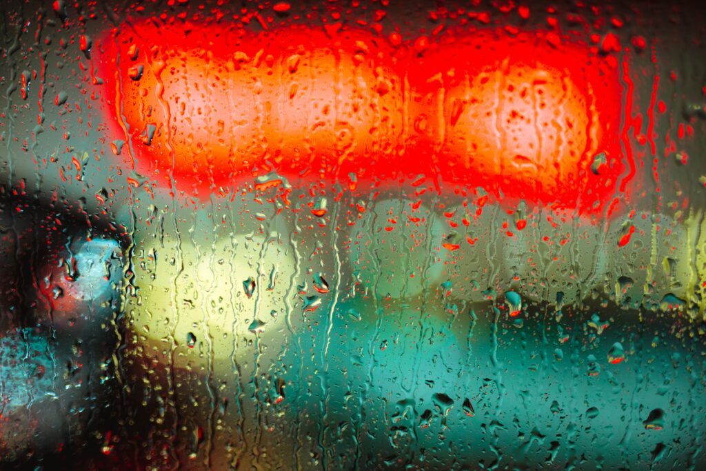 Vibrant Abstract Background: Water Droplets on Glass with Blurred Lights Wallpaper