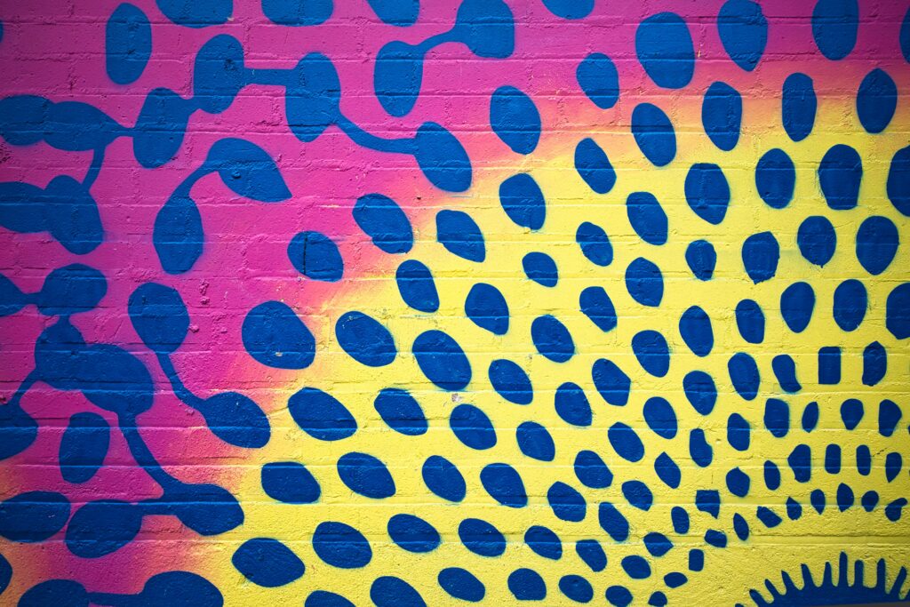 Vibrant Abstract Wallpaper: Blue Shapes on Colorful Pink & Yellow Background
