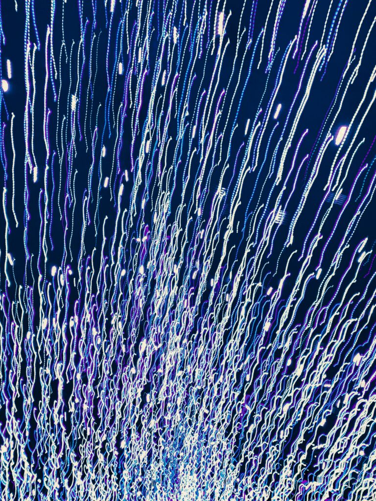 Vibrant Abstract Wallpaper: Long Exposure Light Trails on Blue Background