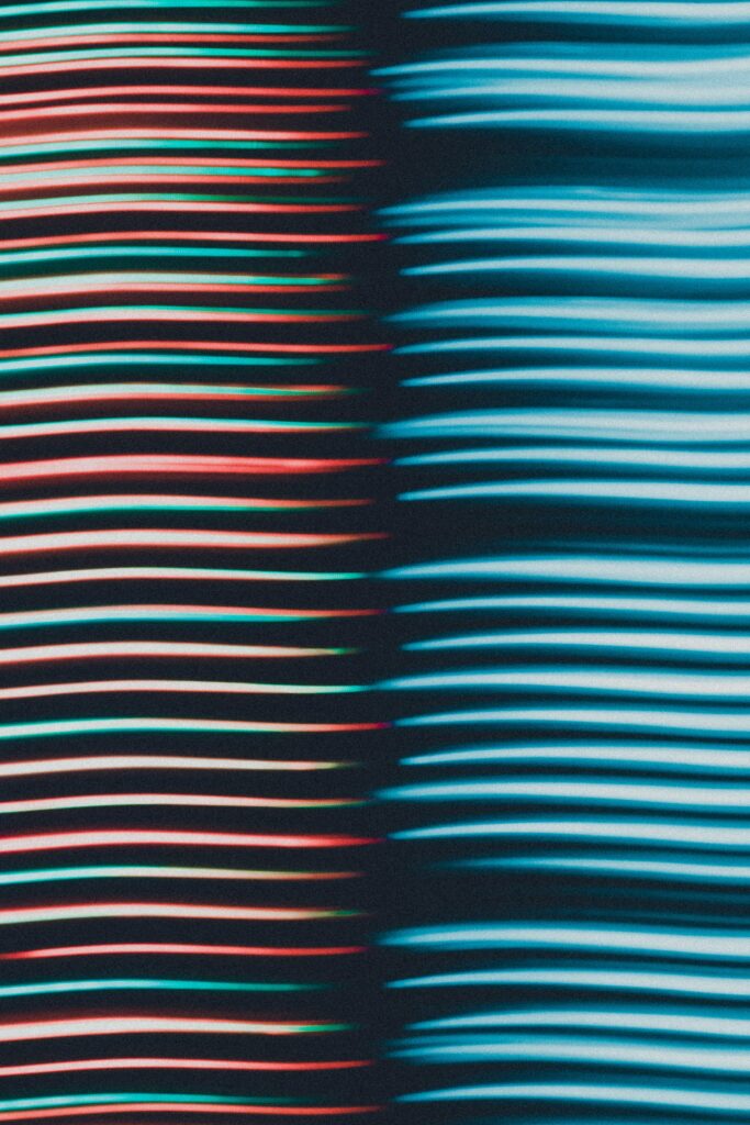 Vibrant Abstract Wallpaper: Flowing Wavy Lines in Red, Green & Blue