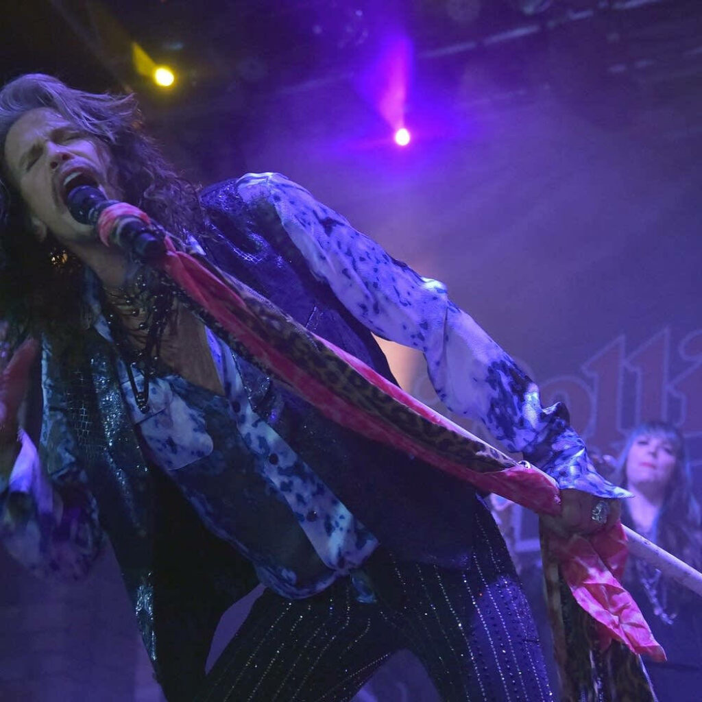 Vibrant Aerosmith Steven Tyler Live Concert Wallpaper Background