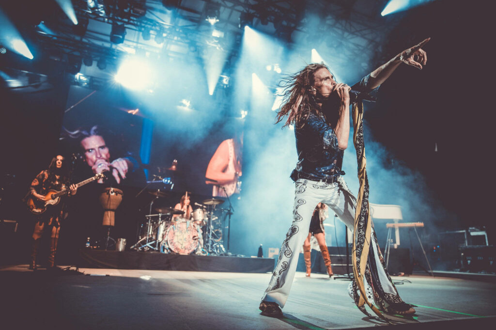 Vibrant Aerosmith Wallpaper: Steven Tyler's Energetic Live Performance