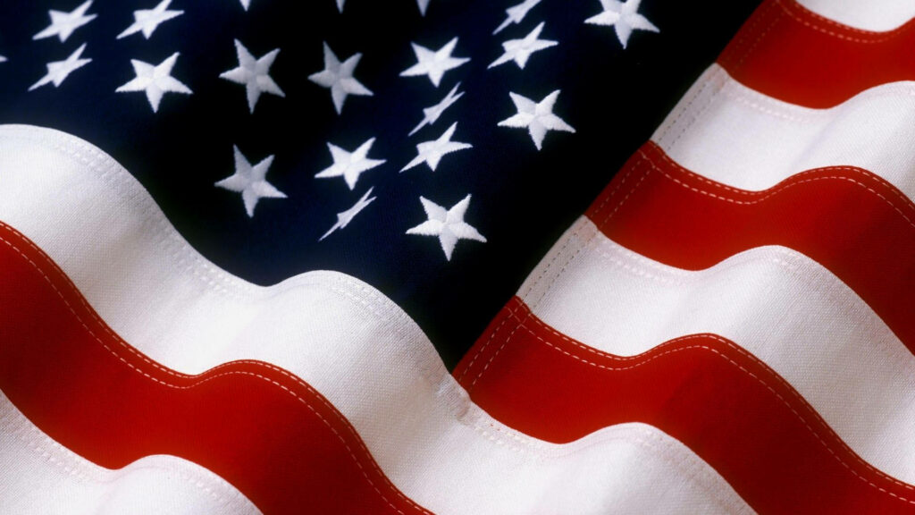 Vibrant American flag wallpaper with bold red white blue colors and bright white stars background