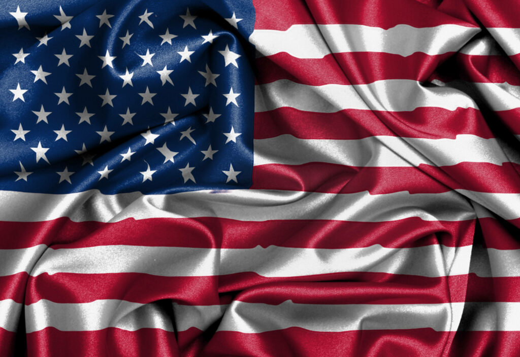 Vibrant American flag wallpaper with bold red white blue colors and realistic fabric textures
