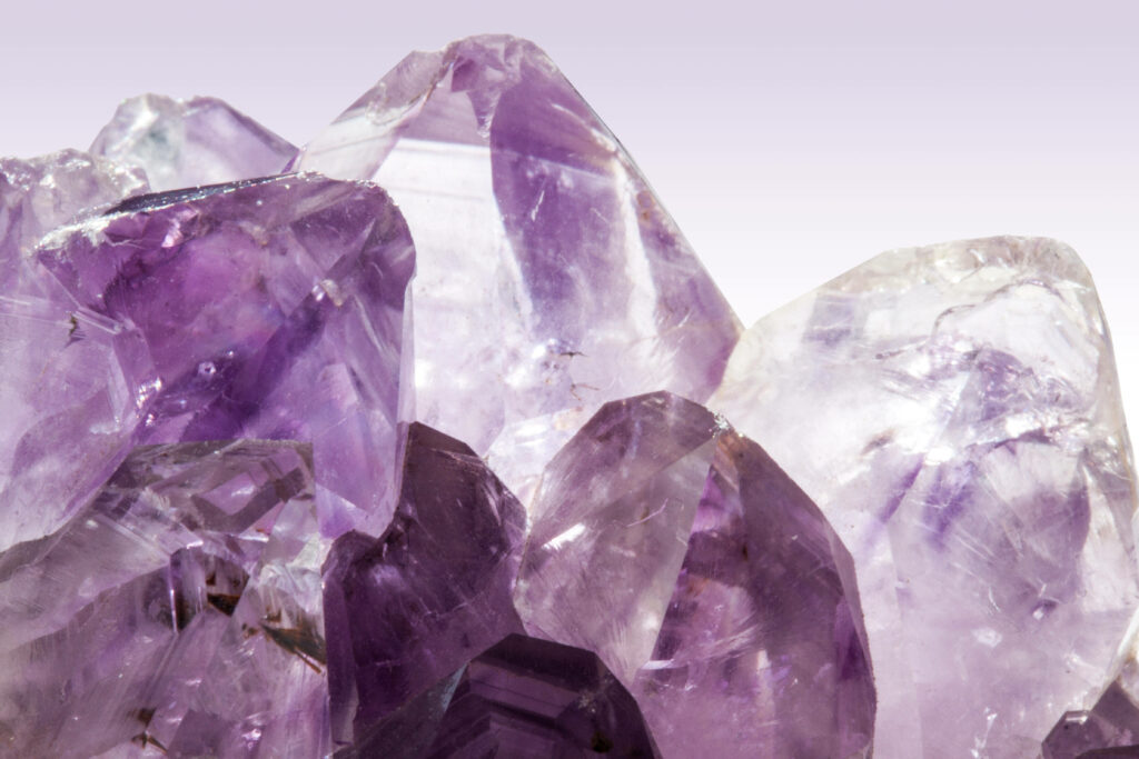 Close-up of vibrant purple mined amethyst shards showcasing detailed crystalline structure wallpaper