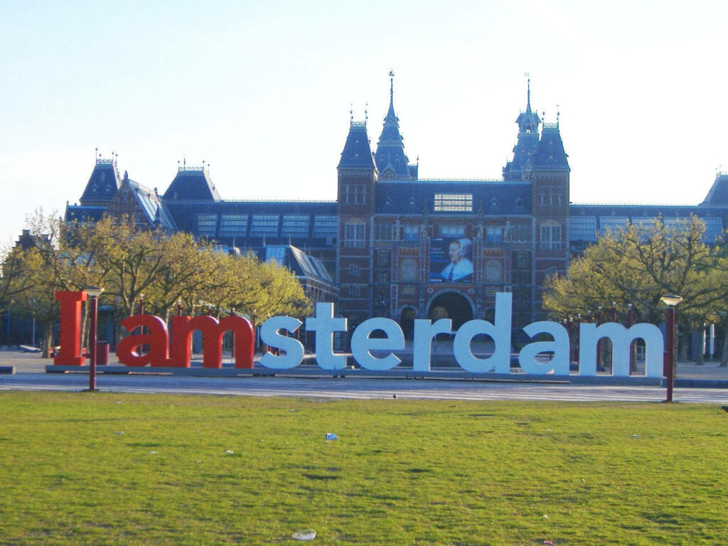 Vibrant Wallpaper: I Amsterdam Sign & Rijksmuseum Against Blue Sky