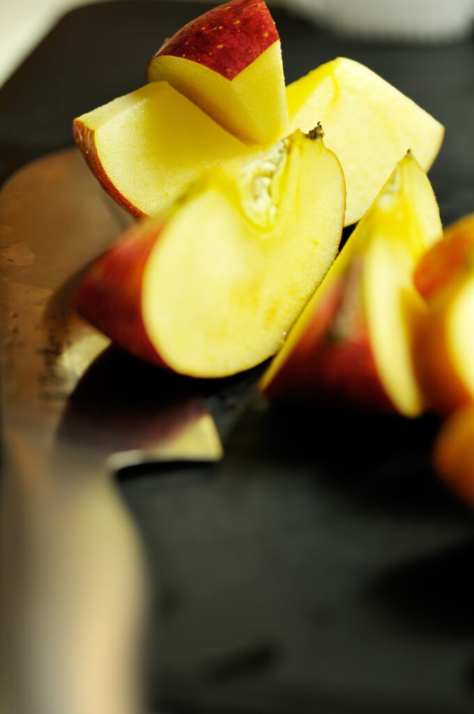 Vibrant Apple Slice Wallpaper: Close-Up Texture & Soft Blur Effect